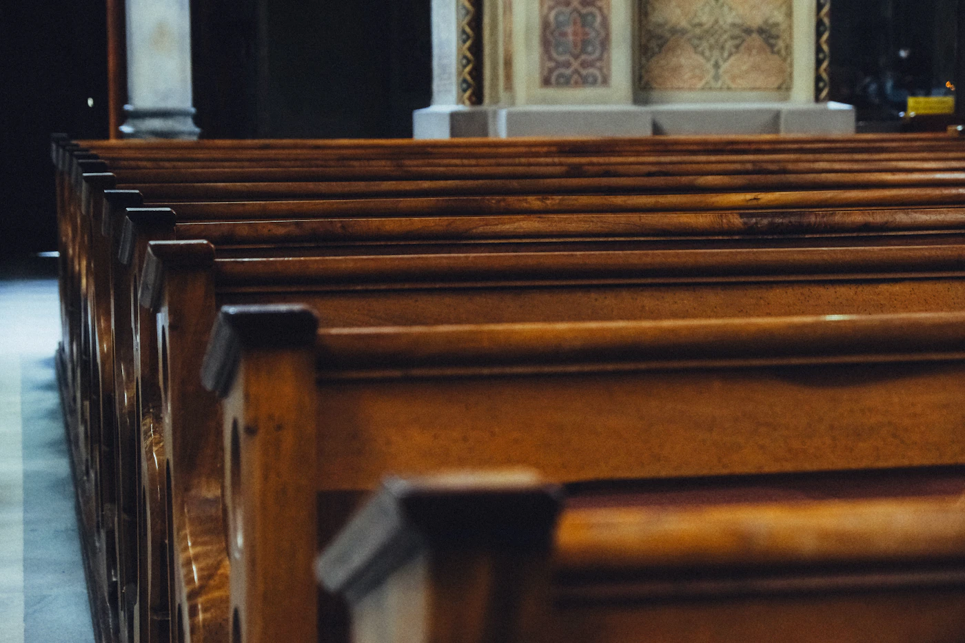 Rows of empty wooden pews inside a church