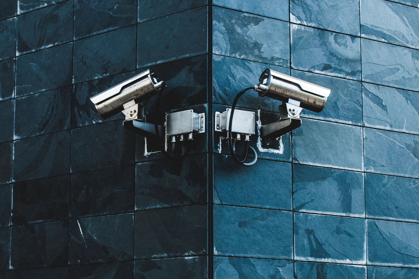 Two exterior cameras mounted on the corner of a building